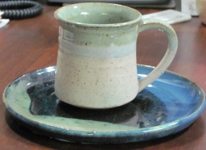 Green pottery mug and blue-green pottery plate